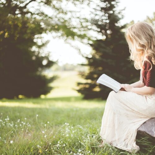 Girl Reading a book in ohio in a field