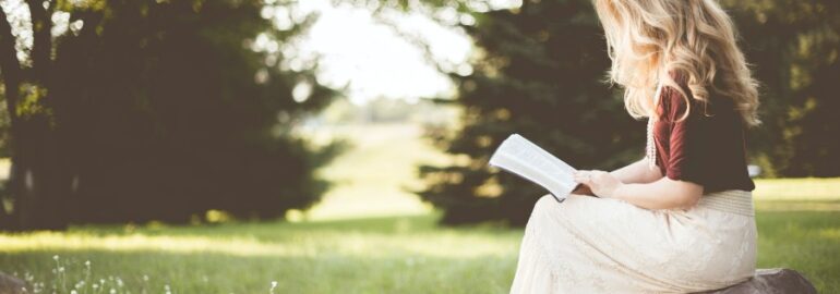 Girl Reading a book in ohio in a field