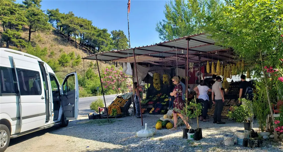 fruit stand vendor with small van parked out in front on a small group tour in Turkey