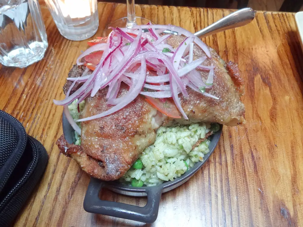 plate filled with Arroz con Pato -must try food of Peru