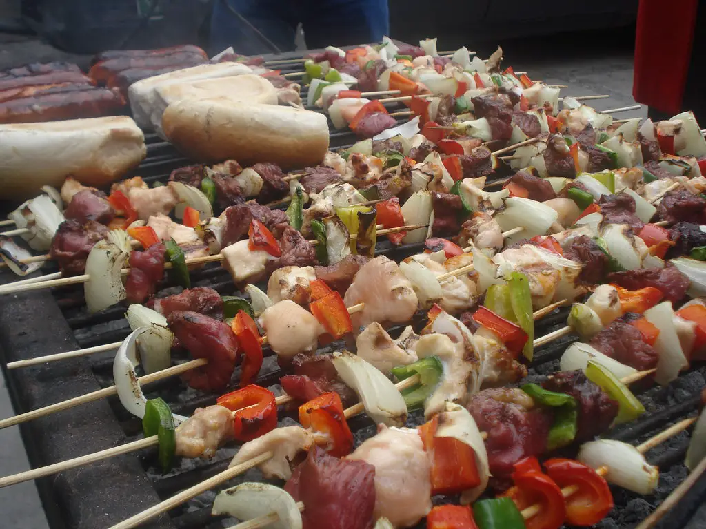 skewers of anticuchos on a grill   traditional food of peru - street food