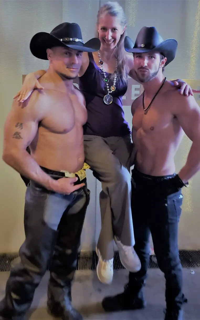 Lady being held up by two muscular guys - Celebrating during my 50th birthday trip to Las Vegas