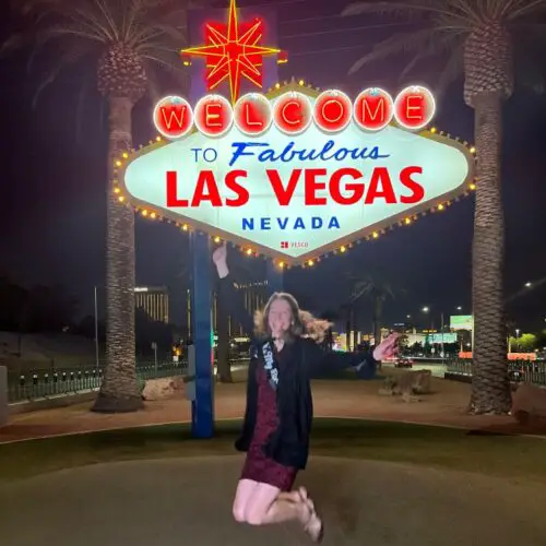 jumping at the Welcome to Las Vegas Sign on 50th birthday trip to Las Vegas