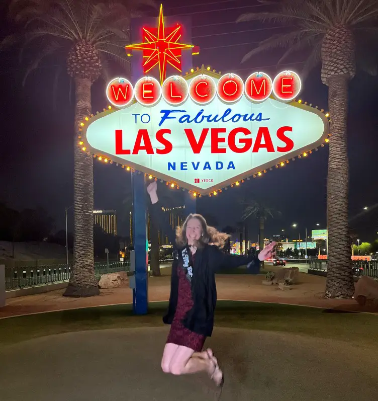 jumping at the Welcome to Las Vegas Sign on 50th birthday trip to Las Vegas