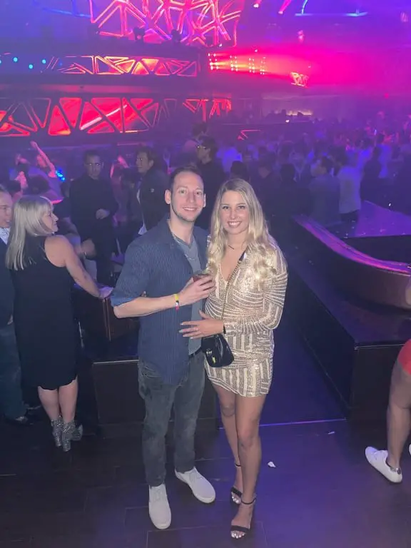 couple holding a drink in neon lights while Celebrating birthday in Las Vegas at Hakassan Night Club