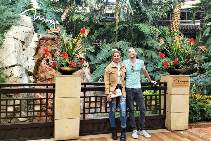 couple standing in front of Mirage gardens in Las vegas