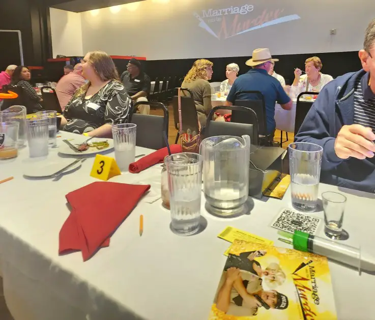 people sitting at a table with glasses and napkins at a show in Las Vegas