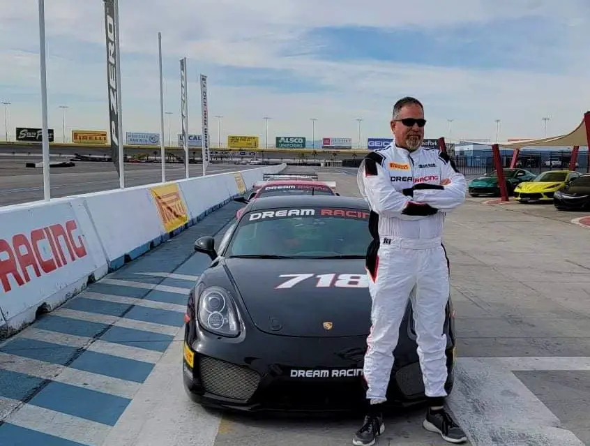 standing in front of racecar at Exotic Racing in Las Vegas for birthday