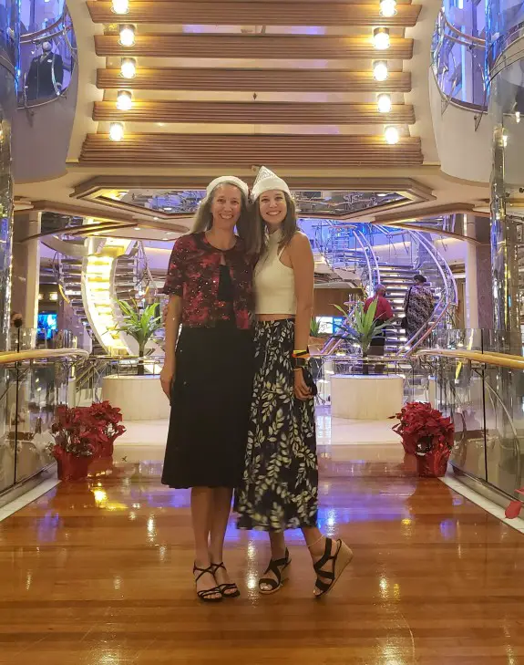 2 people standing in a holiday decorated lobby of cruise ship