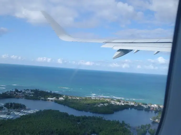 airplane in the sky over some islands