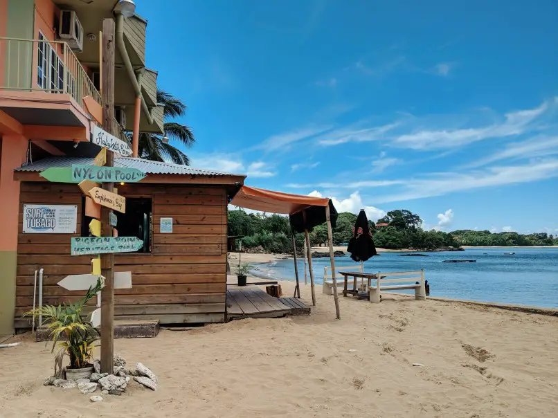 hut on the sandy beach overlooking clear water in tobago