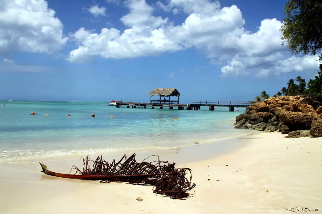 sandy beach with boardwalk in the distance in tobago