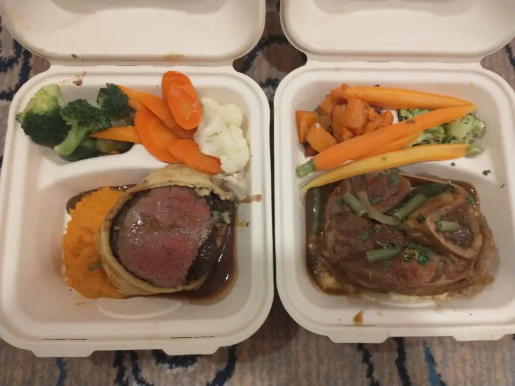 2 styrofoam containers of meat and vegetables for room service during quarantine on a cruise