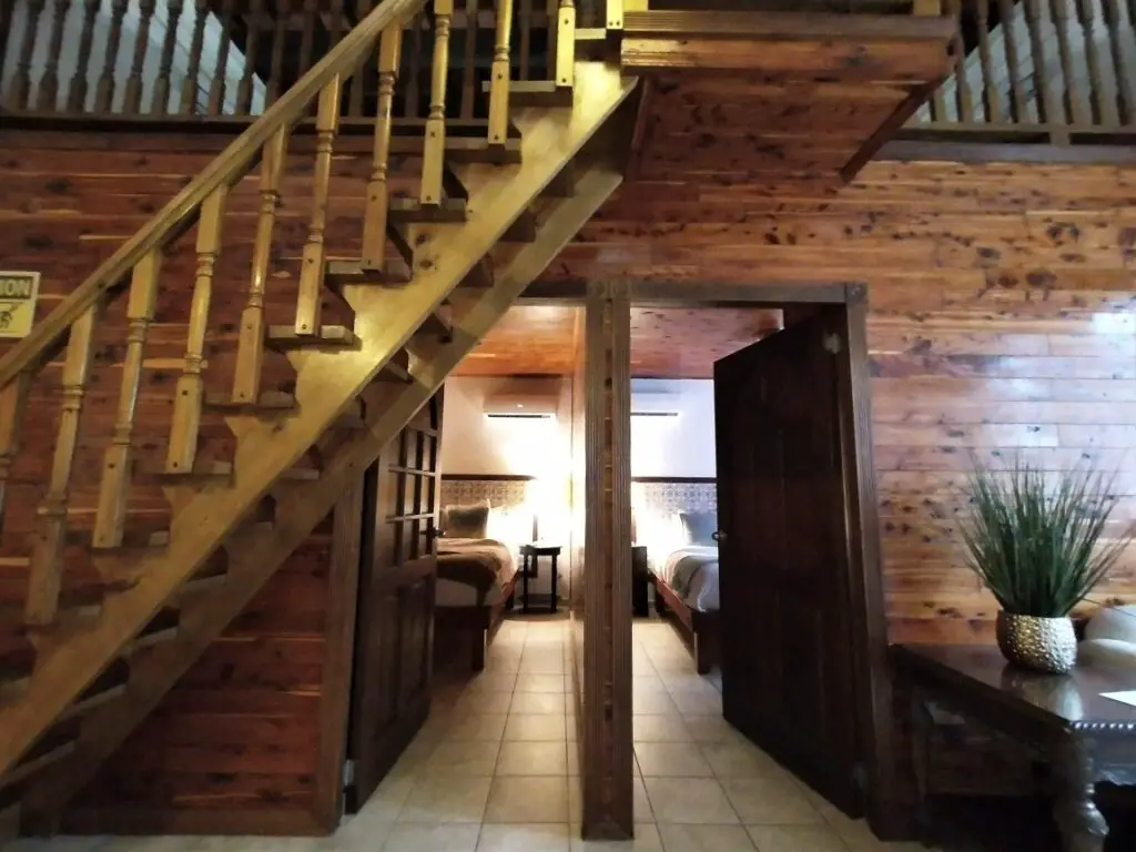Open doorway to 2 bedrooms and a wooden staircase at a hotel in San Juan Puerto rico