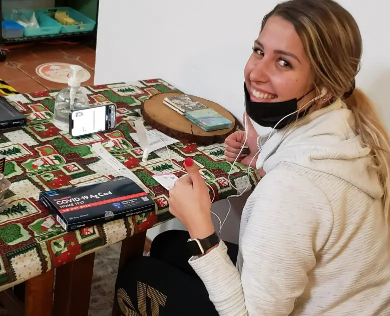 female taking an at home covid test before a cruise during the pandemic