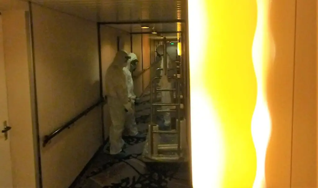 guys in the hallways wearing biohazard suits