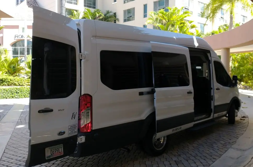 white van with doors open waiting to transport passengers for quarantine hotel