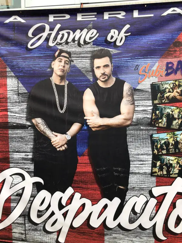 mural of two men standing in front of Puerto Rico flag that reads Home of Despacito
