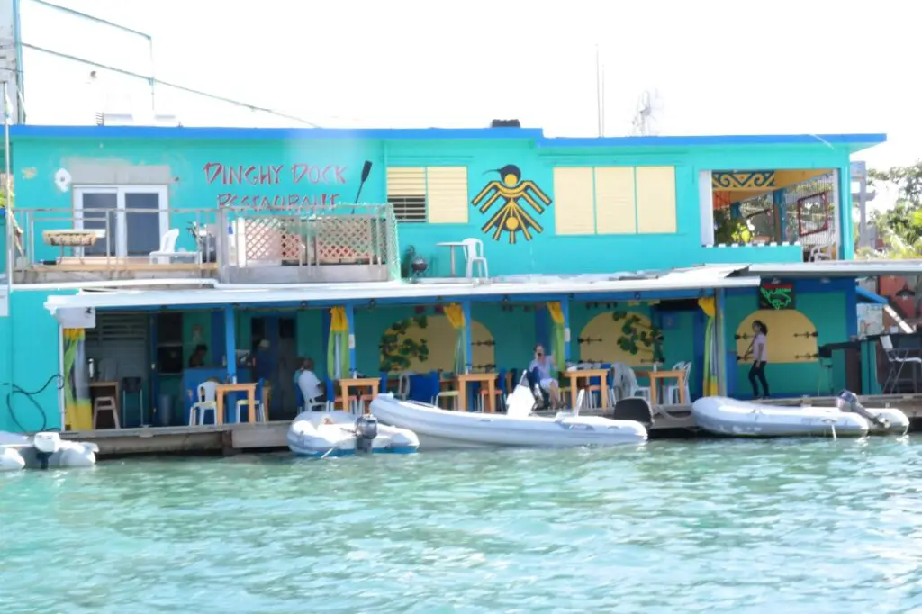 Bright blue restaurant on the water with boats outside it to eat for good food in Culebra Puerto Rico