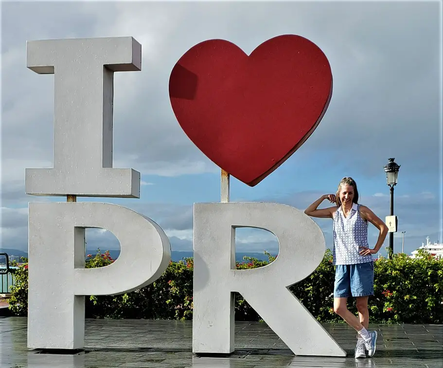 lady standing by a sign that says I heart Puerto Rico in san juan during a walking tour