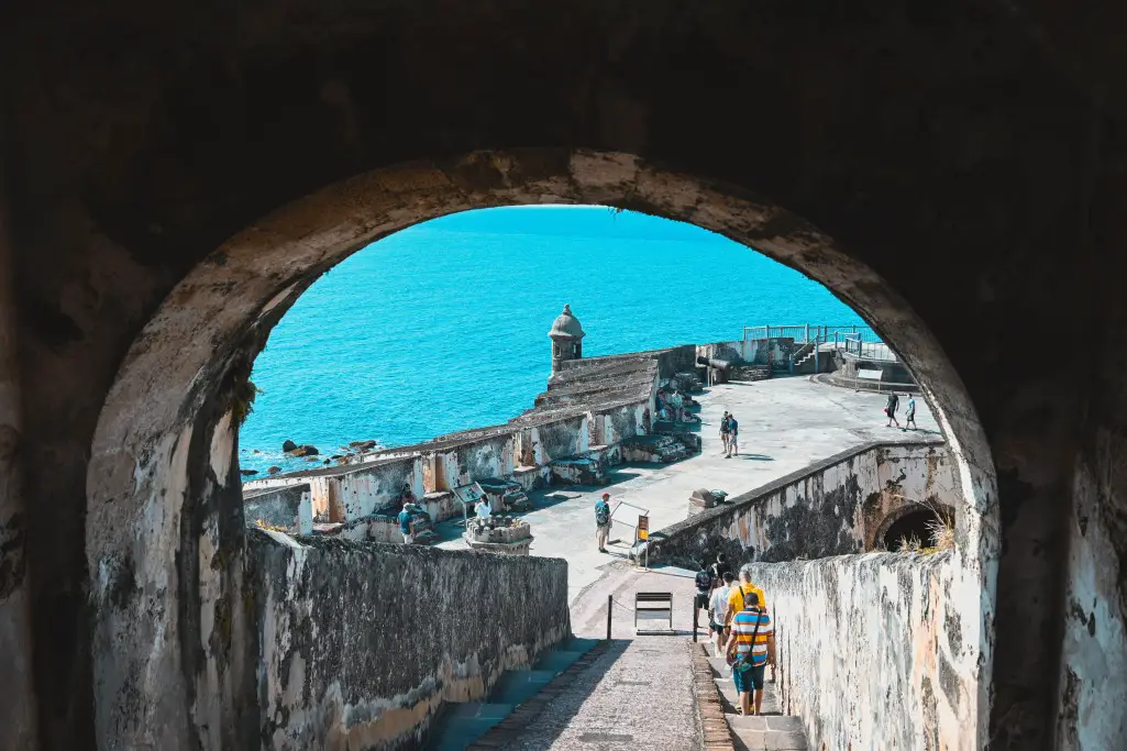 old archway overlooking a fort and water in san juan puerto rico