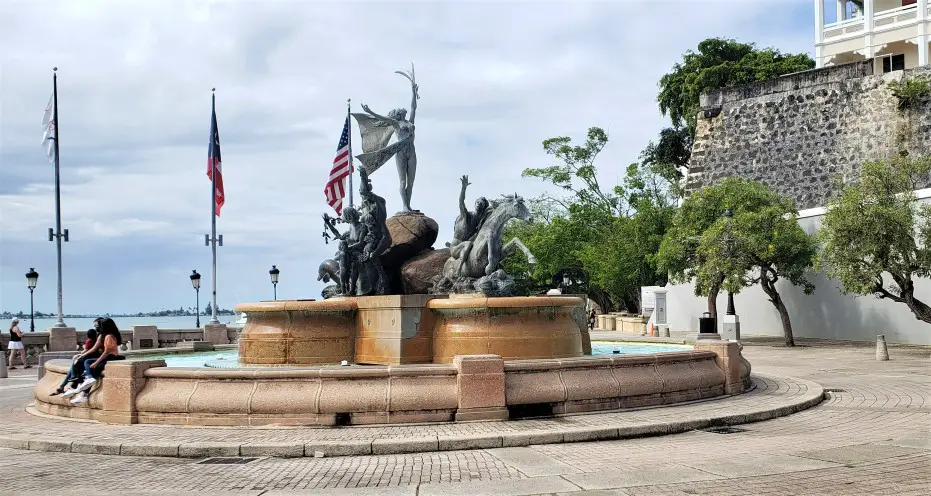 Raices Founatain with statues overlooking the water at Paseo de la Princesa in Old San Juan