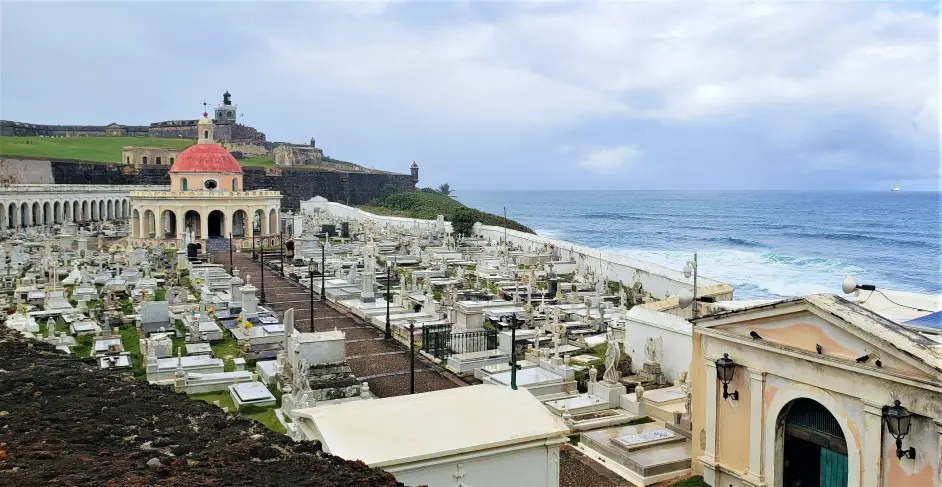 lots of old cemetary headstones in a cemetary overlooking the blue water-Santa María Magdalena de Pazzis Cemetery in Old San Juan