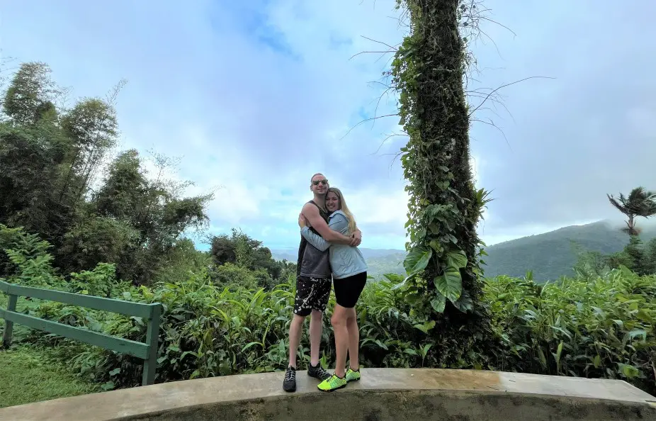 couple hugging in front of green nature in El Yunque National Forest on a vacation in Puerto Rico for 3 days