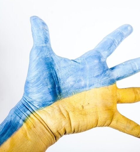 blue and yellow outstretched hand in Ukraine colors