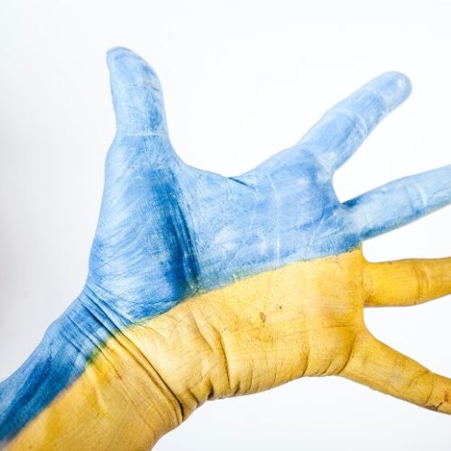 blue and yellow outstretched hand in Ukraine colors