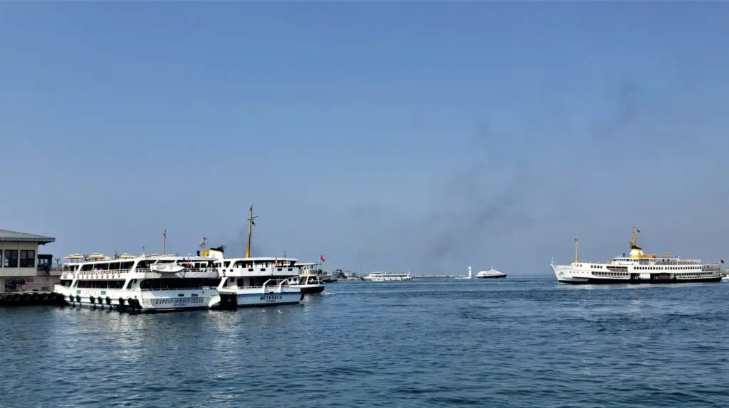 many ferry boats in the water providing a great view of the bosphorus