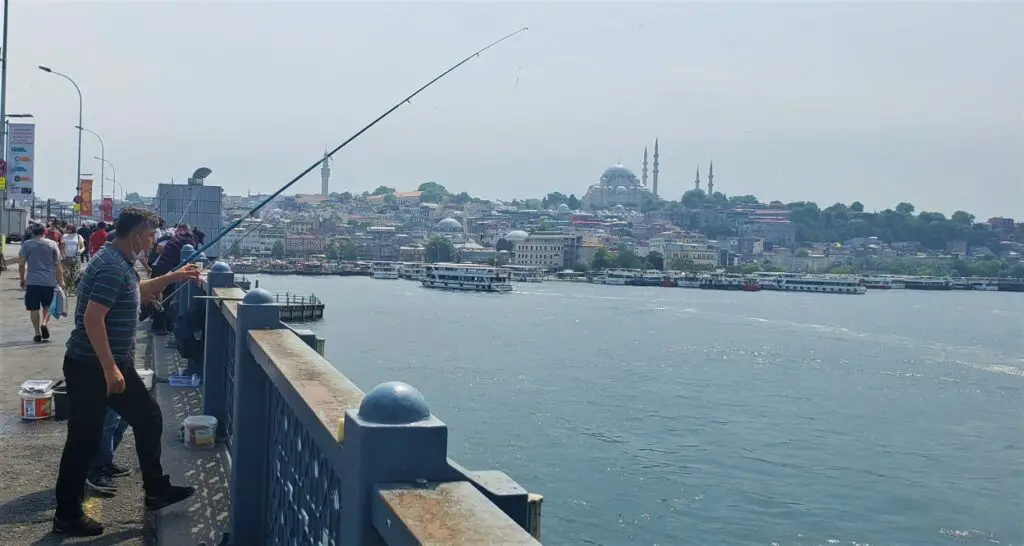 fishermen on the bridge overlooking the water in Istanbul on the Galata Bridge