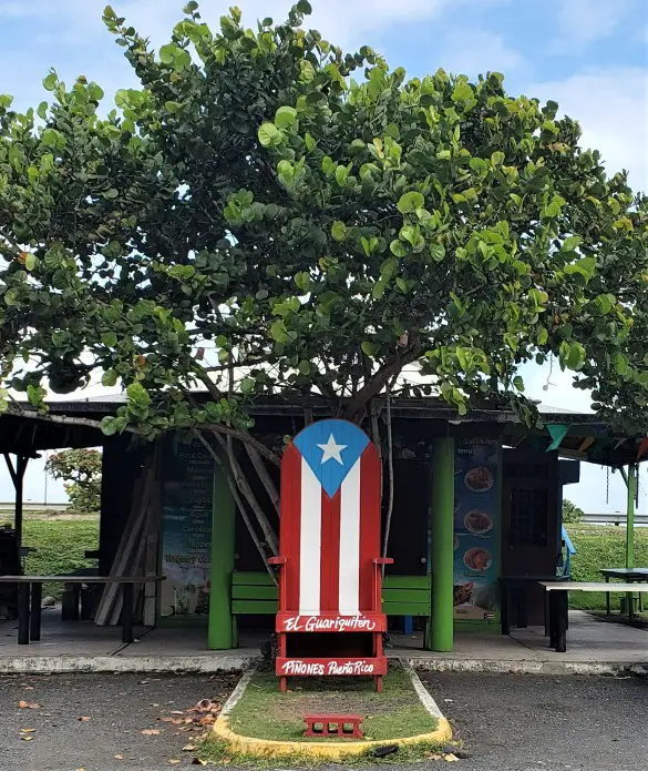 Wooden Puerto Rico Chair in front on the Pinones Food kiosk in Puerto Rico