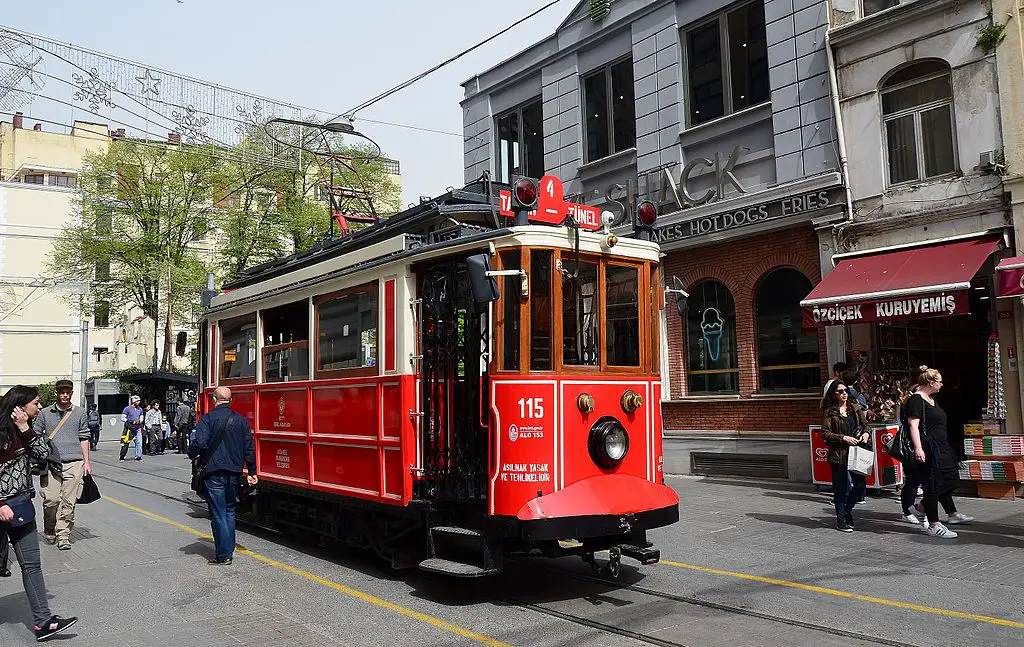 red tram running through the middle of the street for a great photo in Istanbul