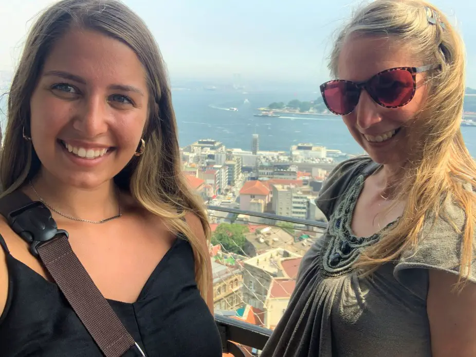 2 ladies posing for a the best view of Istanbul city in the distance from the top of Galata Tower