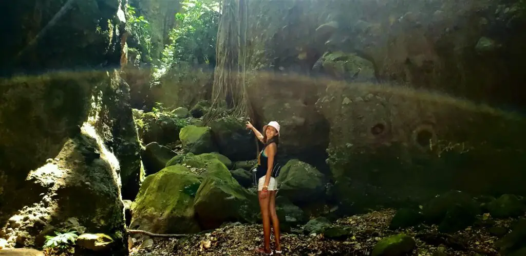 girl pointing the way to the Best Hiking in St Kitts on Bat Cave Hike