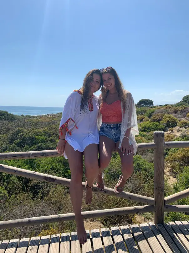 two girls on a railing at Dunas de artola - fun beach in Malaga Spain