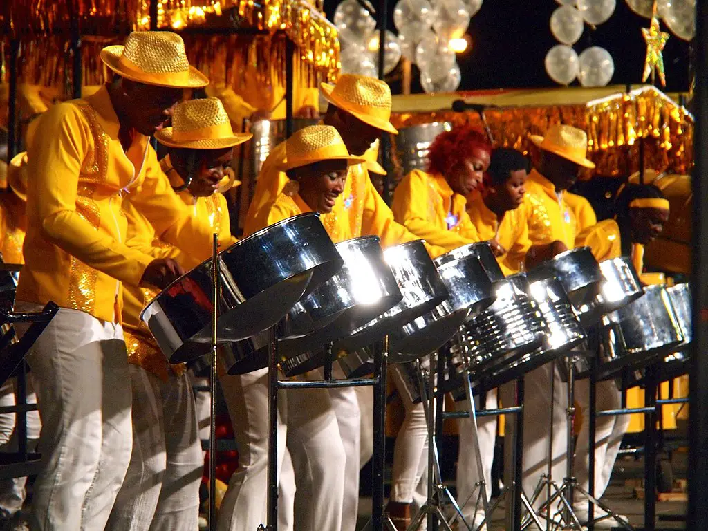 people in yellow outfits playing steel pan drums at Carnival in Trinidad