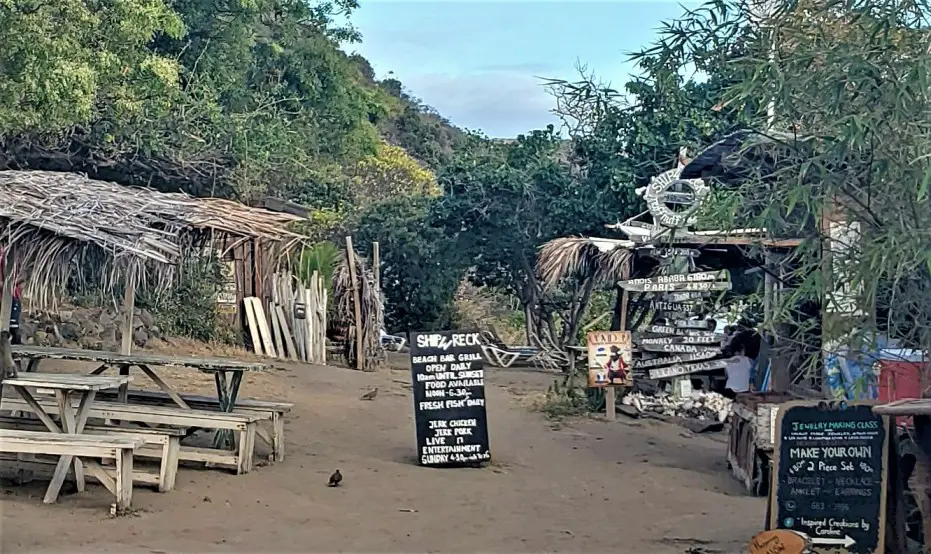 rustic shacks and signs at the Entrance to Shipwreck Beach in St Kitts