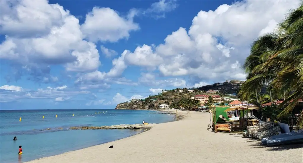 st kitts beach with sand and water and not many people on the beach but a few vendor stalls