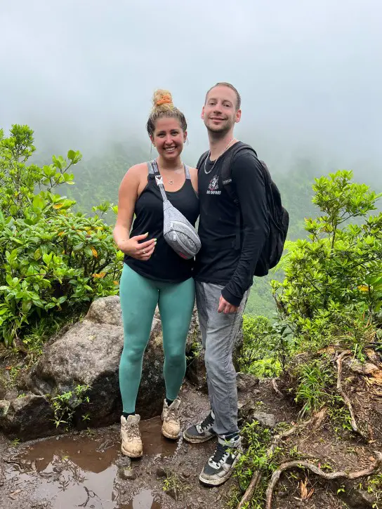2 people standing on the side of a volcano mountainside fanny pack to bring on a hike to Mt Liamuiga volcano