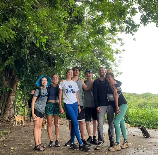 large group of people in a clearing in the rainforest during a group hike tour Mt Liamuiga volcano