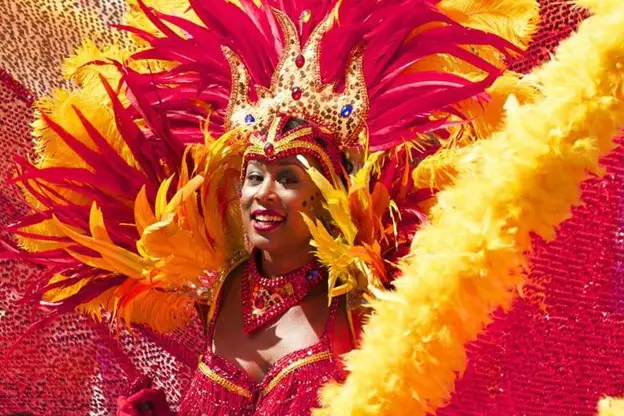 lady in bright feathery outfit at Carnival in Port of Spain Trinidad