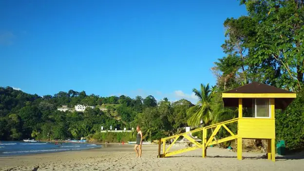yellow lifeguard stand on the beach in trinidad at Las Cuevas Beach