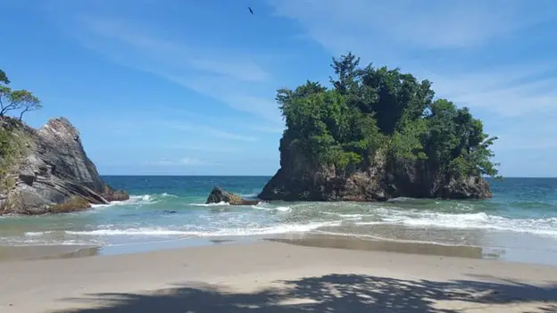 rock jutting out of the water at Macqueripe Beach in Trinidad