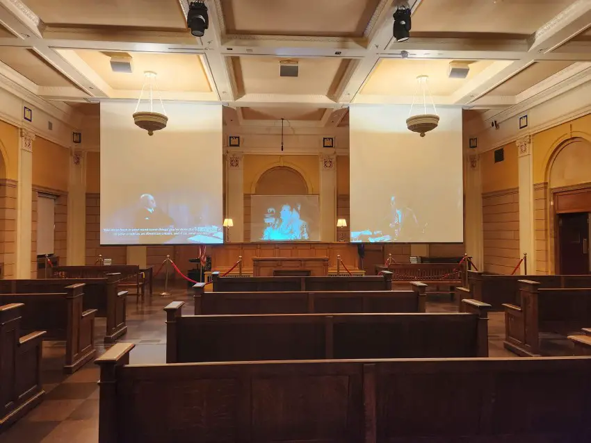 benches in a courtroom with screens at the front depicting mobsters at the Mob Museum in Las Vegas