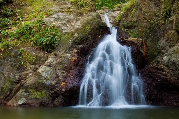 beautiful waterfall over rocks in trinidad