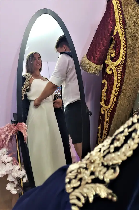 looking at lady in a mirror Being fitted for the authentic costumes for our rooftop photoshoot at Taht Istanbul