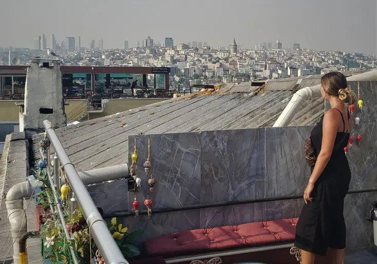 girl standing on the rooftop in Istanbul looking at the city in the distance in Istanbul