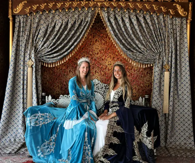 two ladies in royal cloaks and crowns in a photo shoot in Istanbul